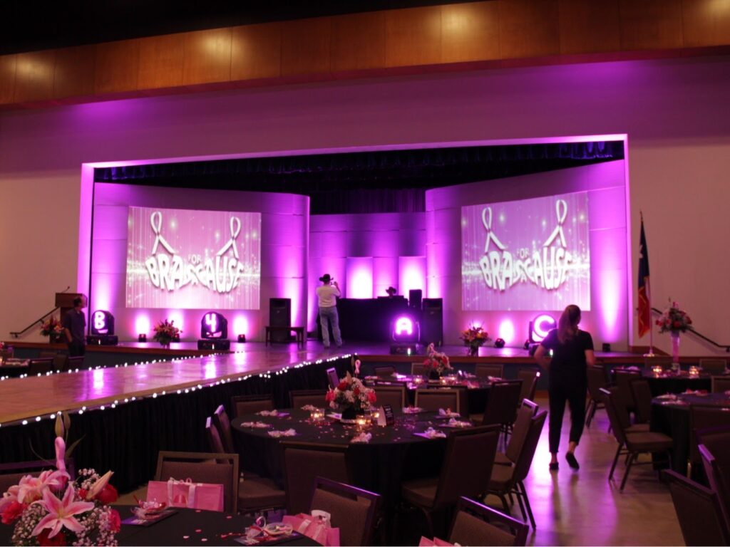 Large video screens on stage at a banquet party