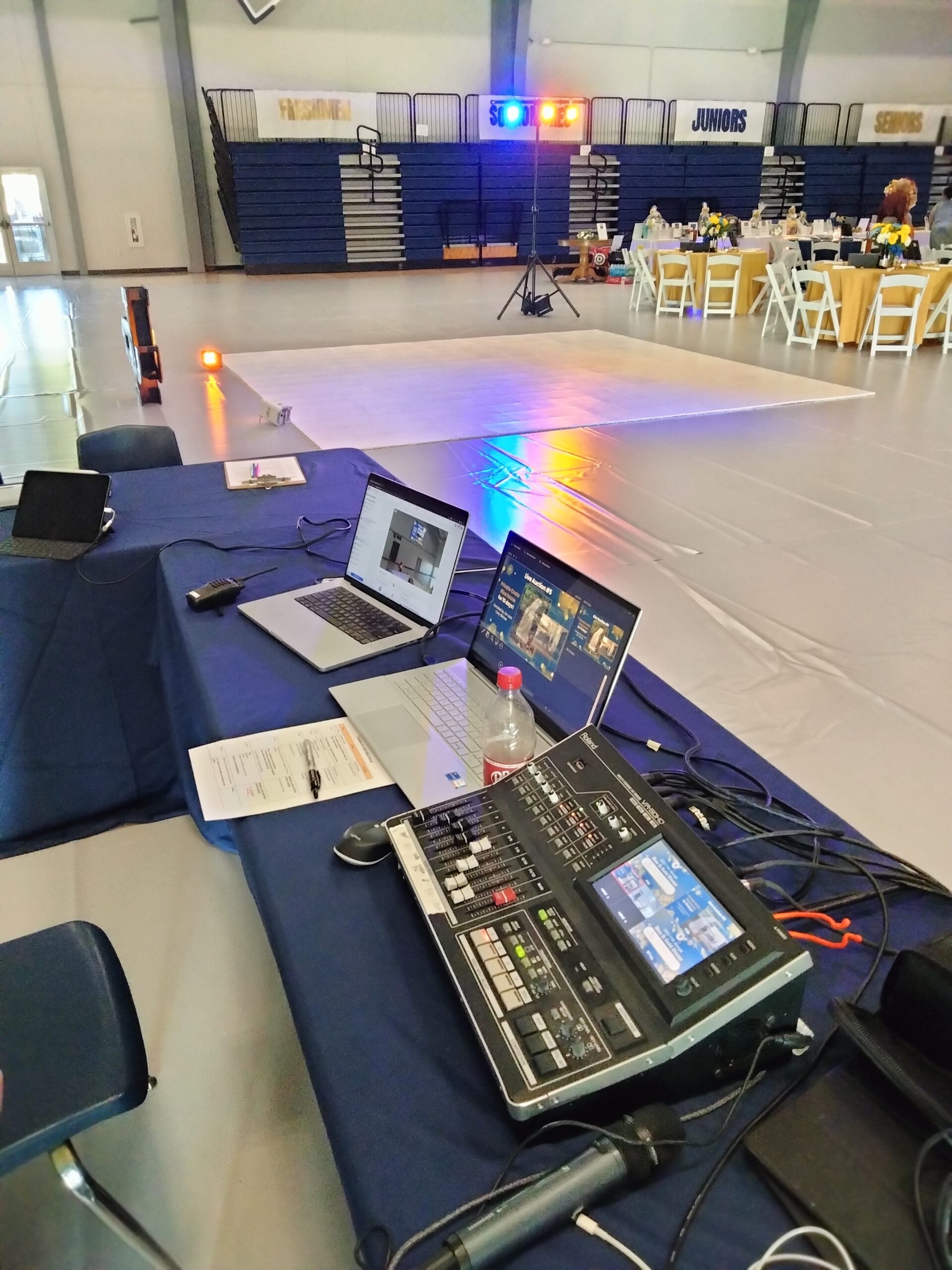 Audio video mixer with computers and a dance floor in the background